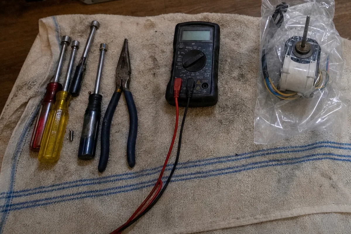 Hand tools and a meter packed back onto the drop cloth at the end of a job